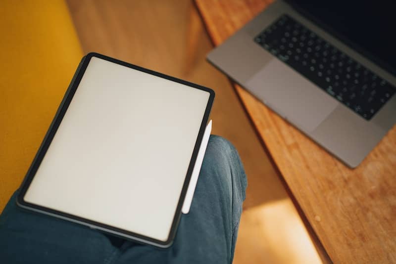 A laptop computer sitting on top of a wooden desk