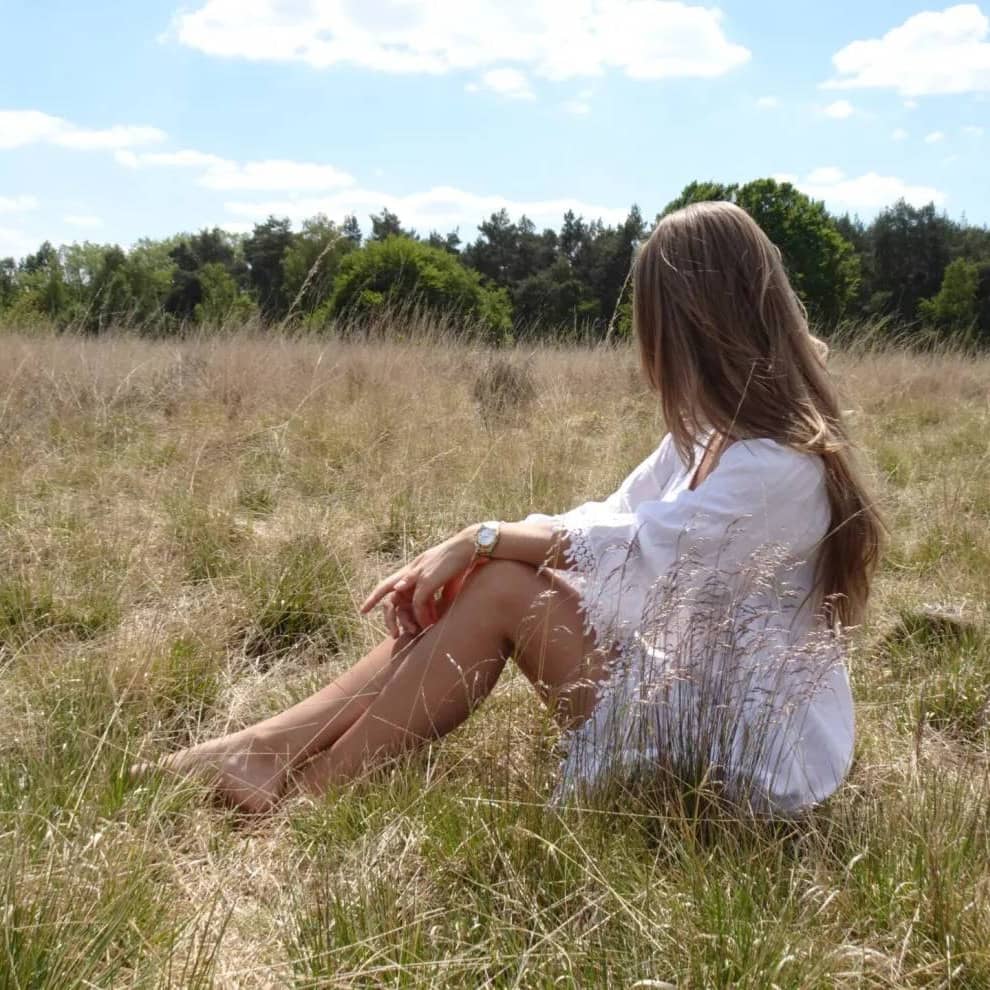 Woman holds the sun in her hand.