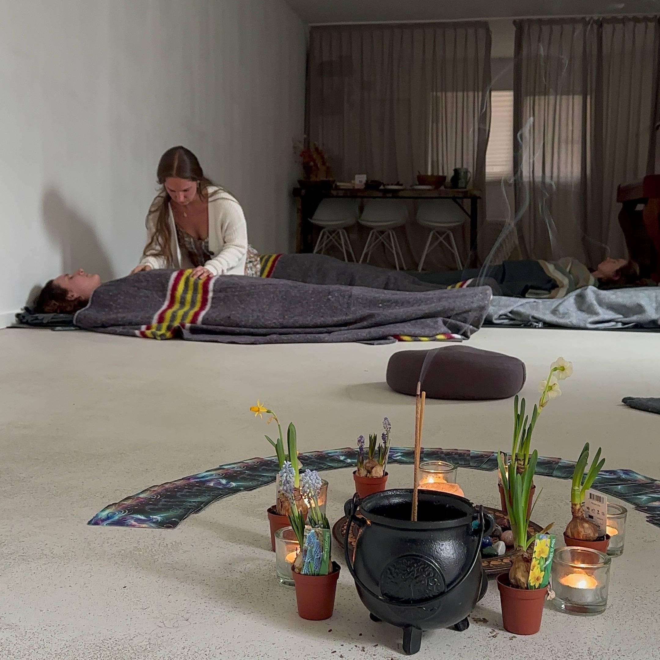 Moss-covered branches hang in a lush forest.