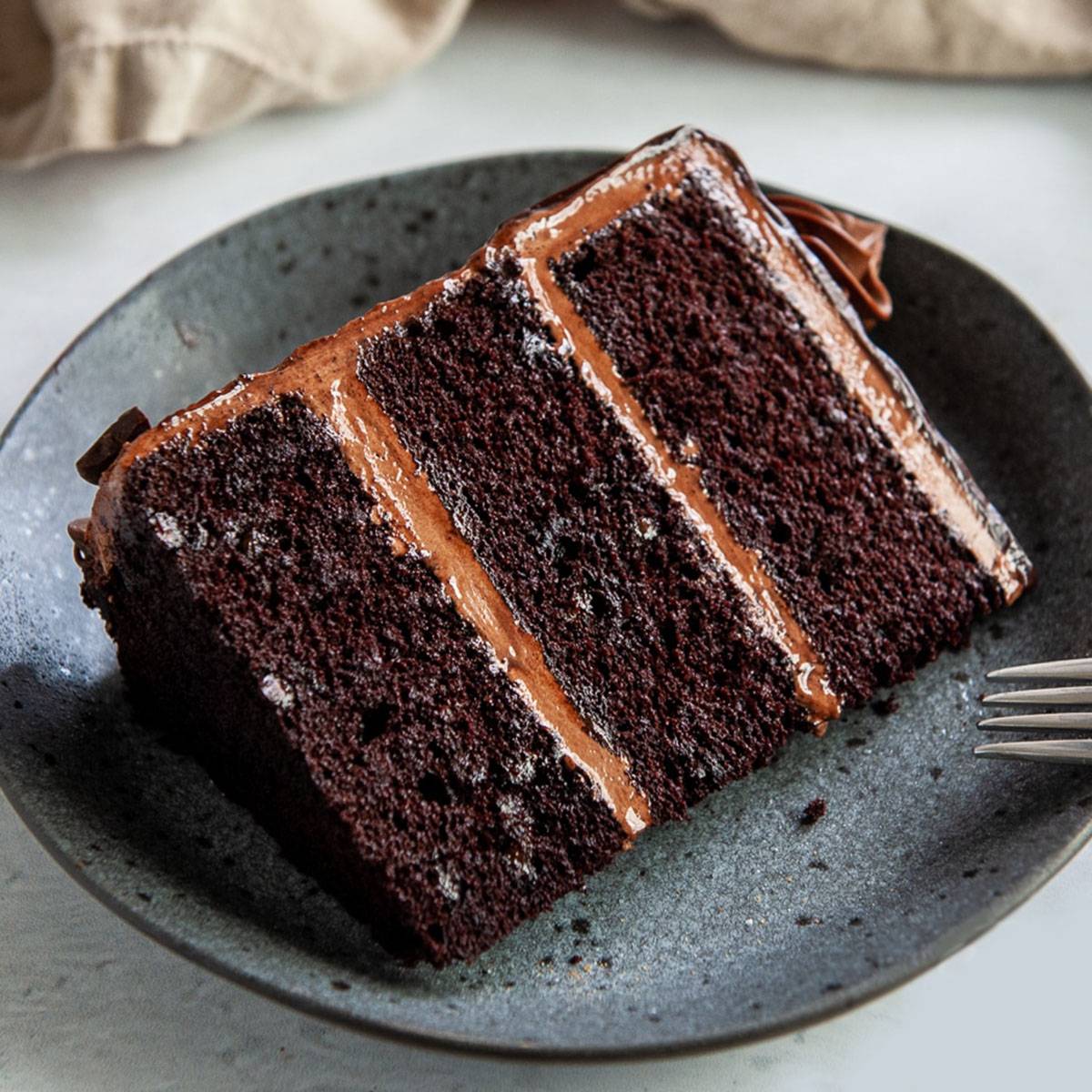close up of a slice of death by chocolate cake on a grey plate