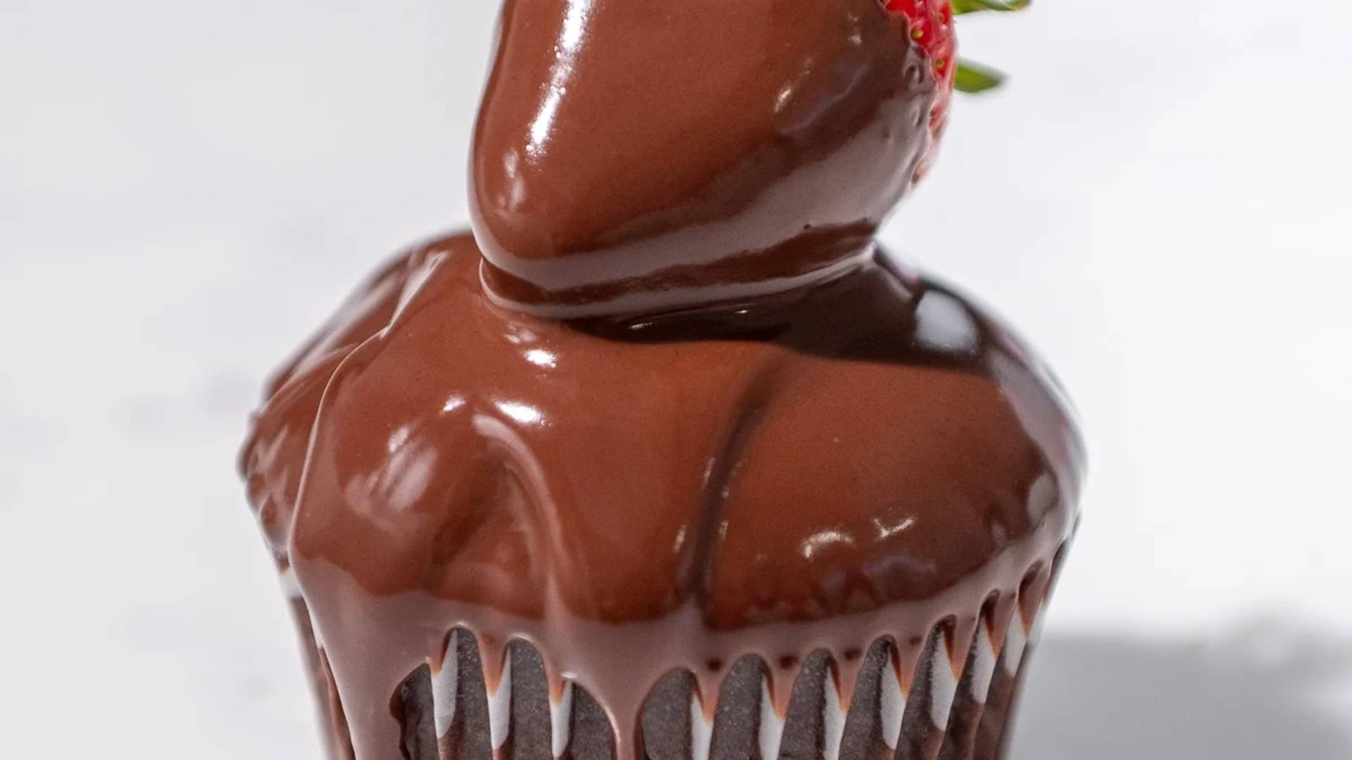 close up of ganache on a strawberry cupcake