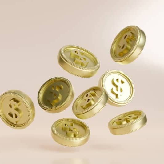 A bunch of gold buttons flying in the air