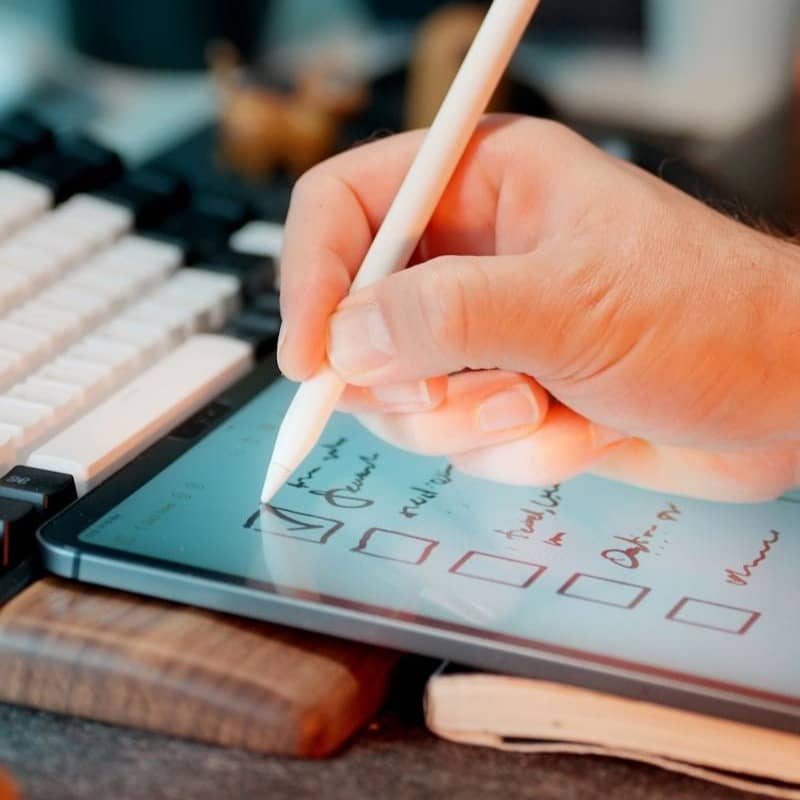 Someone is using a stylus on a tablet.