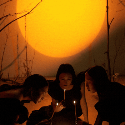 brujes gathered aroud candles