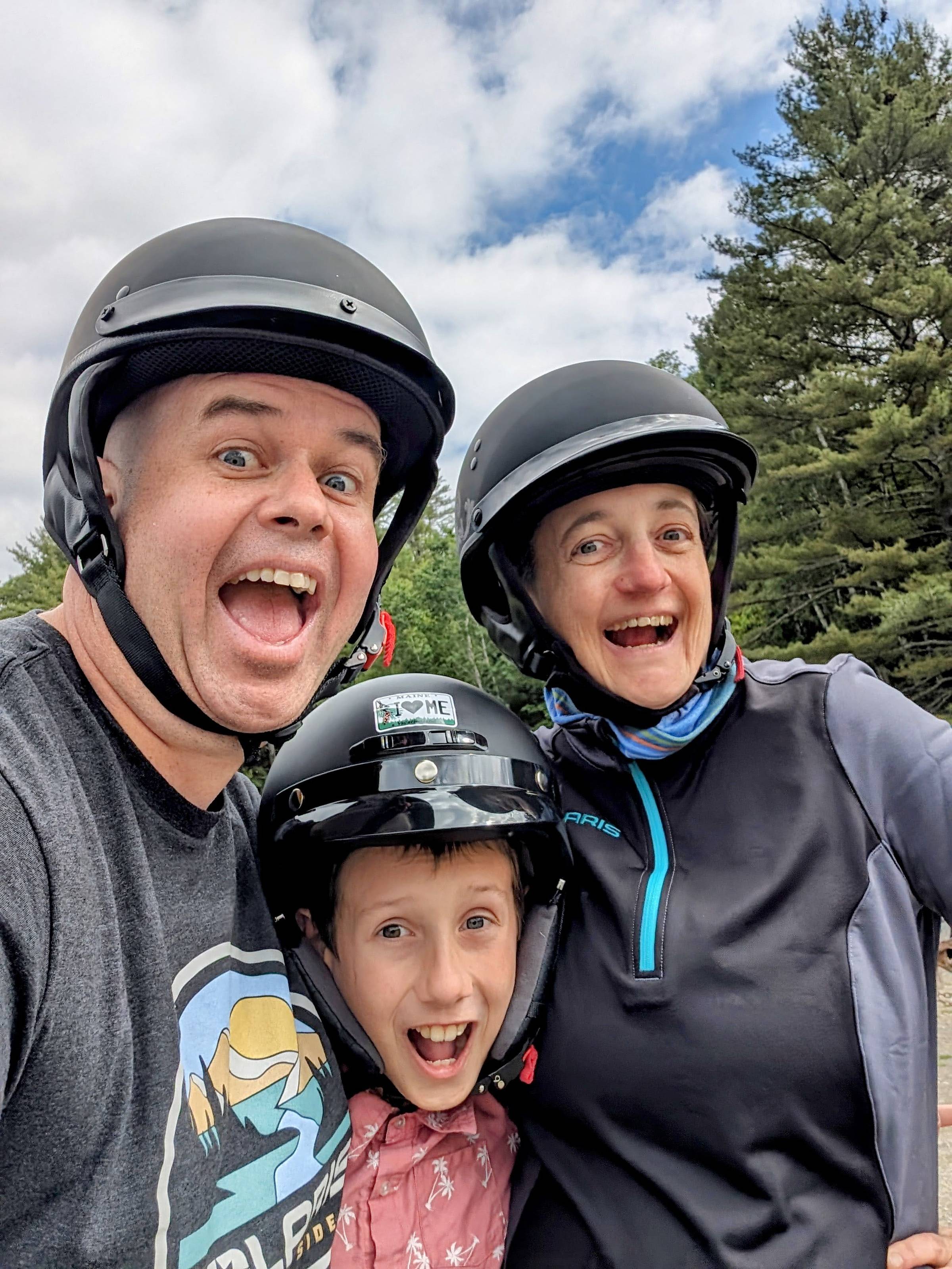 Stephie her son and her husband smiling at the camera