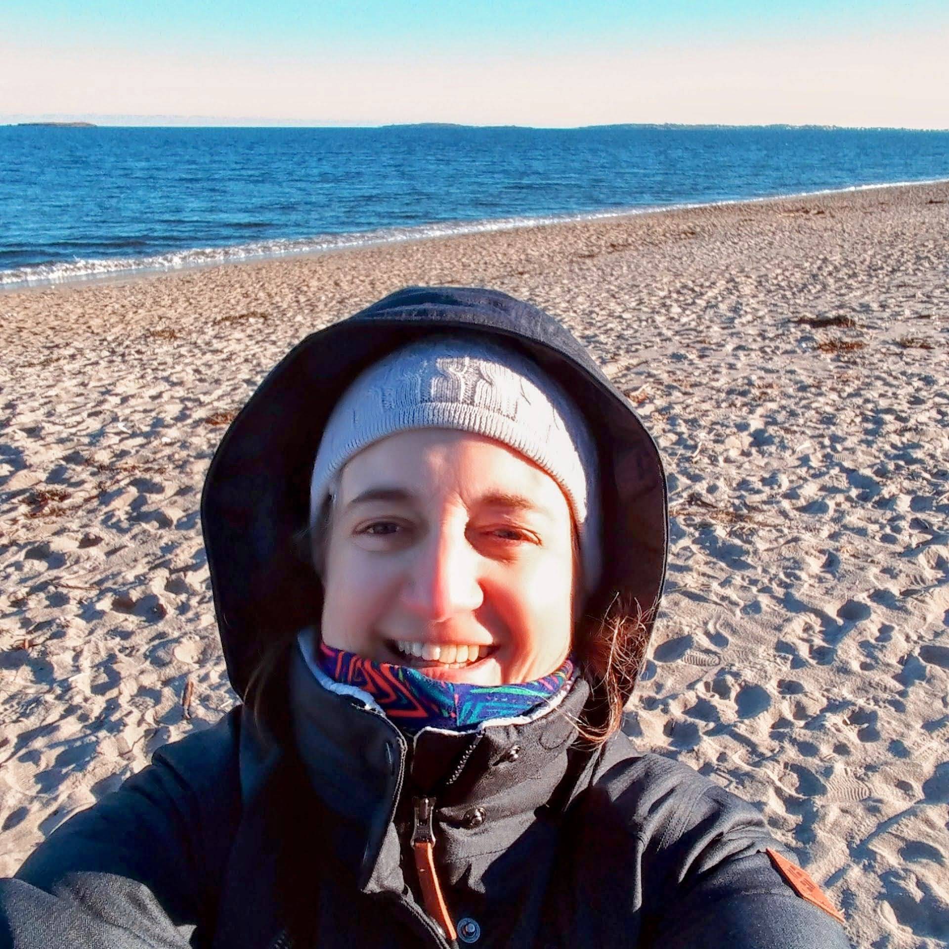 Stephie's profile picture, she's wearing a blue winter coat and a elf hat, smiling at the camera.