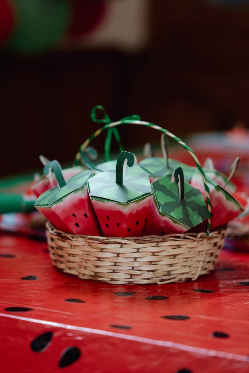 Watermelon-themed treats sit in a decorative basket.