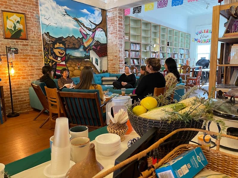 A group of people sitting at a table in a restaurant