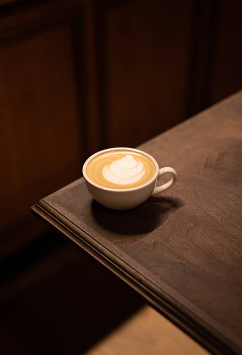 A cup of coffee sitting on top of a wooden table