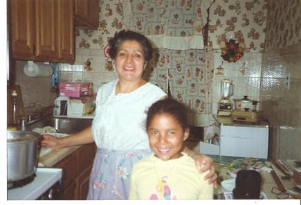 Jessica as a little girl in the kitchen with her mom. 