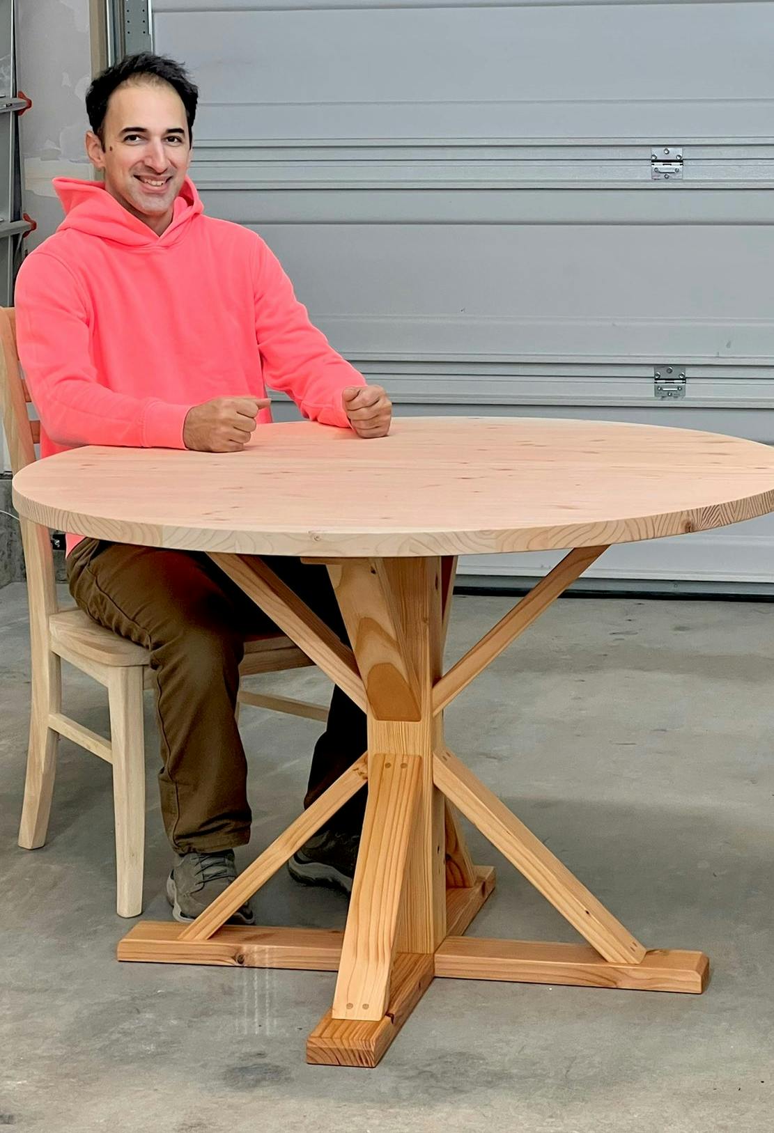 Daniel with a wooden table he built himself