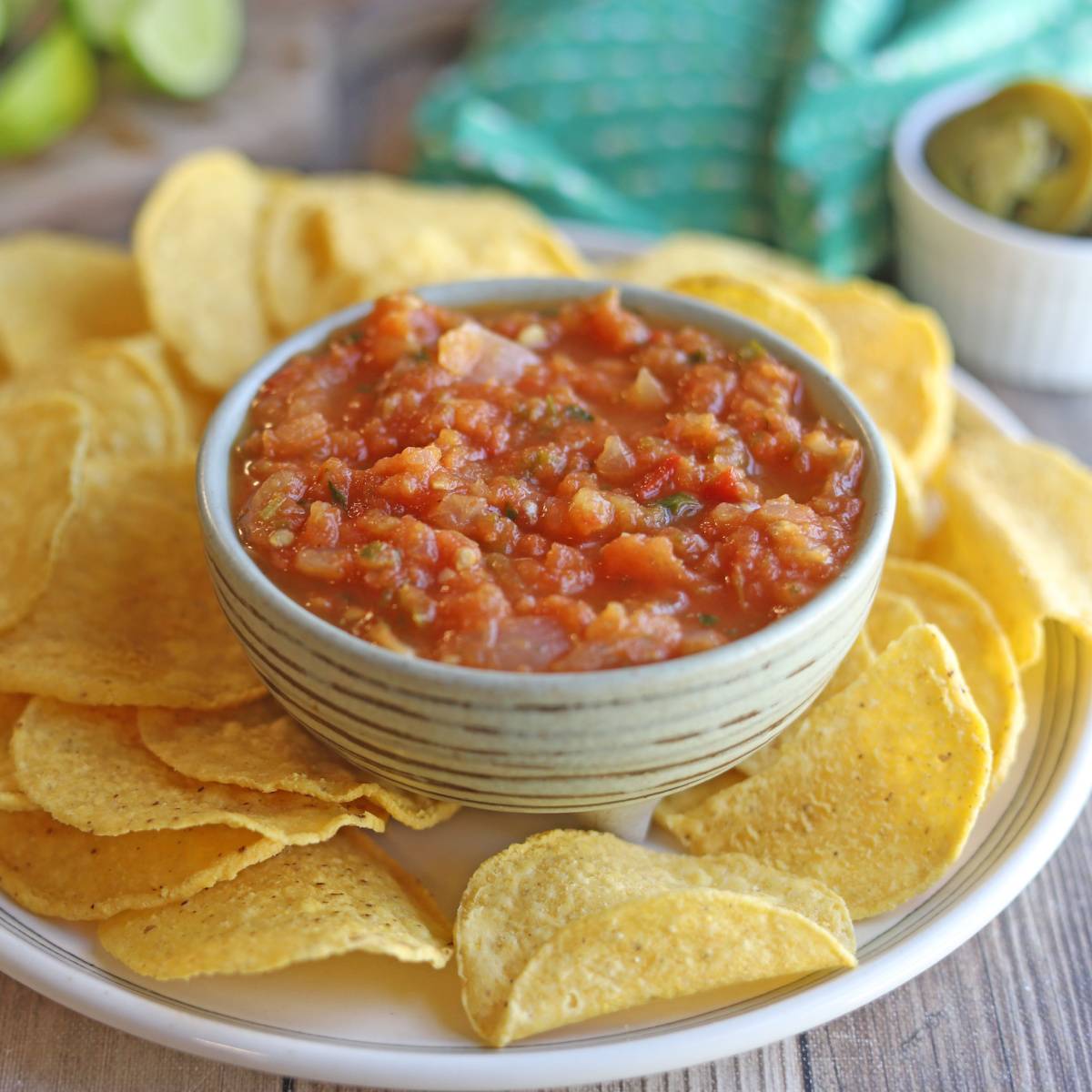 Roasted tomato salsa in bowl by tortilla chips.