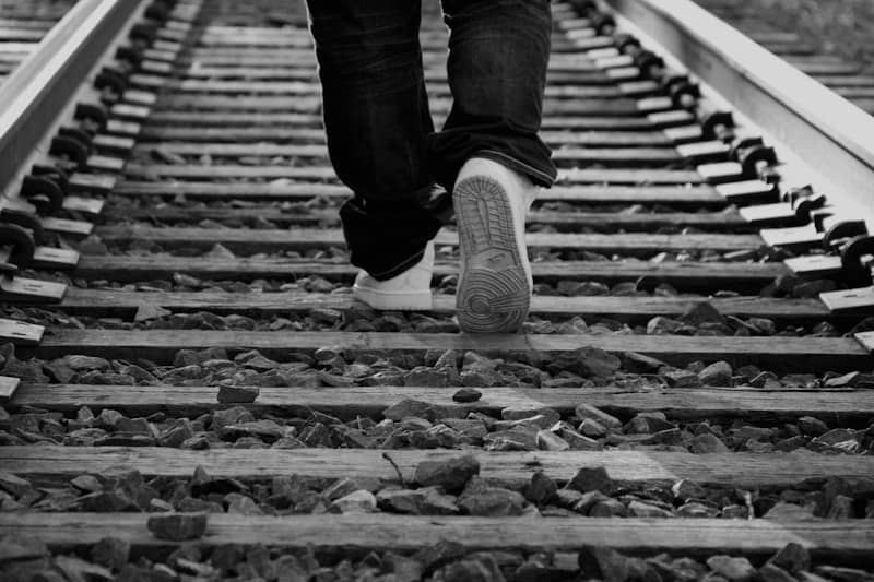Person walking on railroad tracks