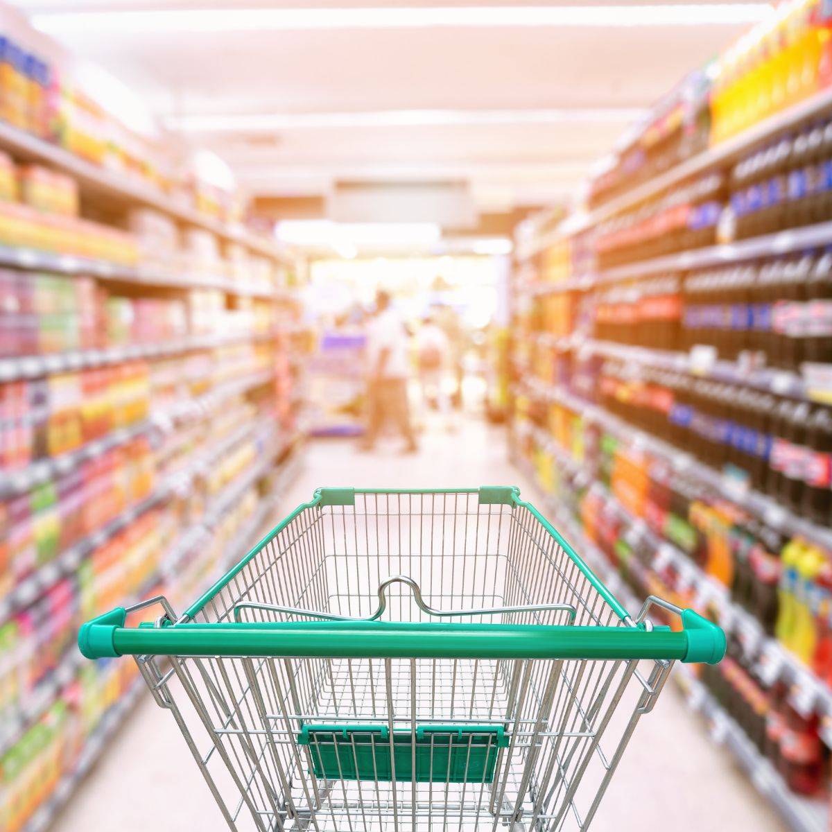 supermarket aisle with trolley to illustrate how to shop sustainably