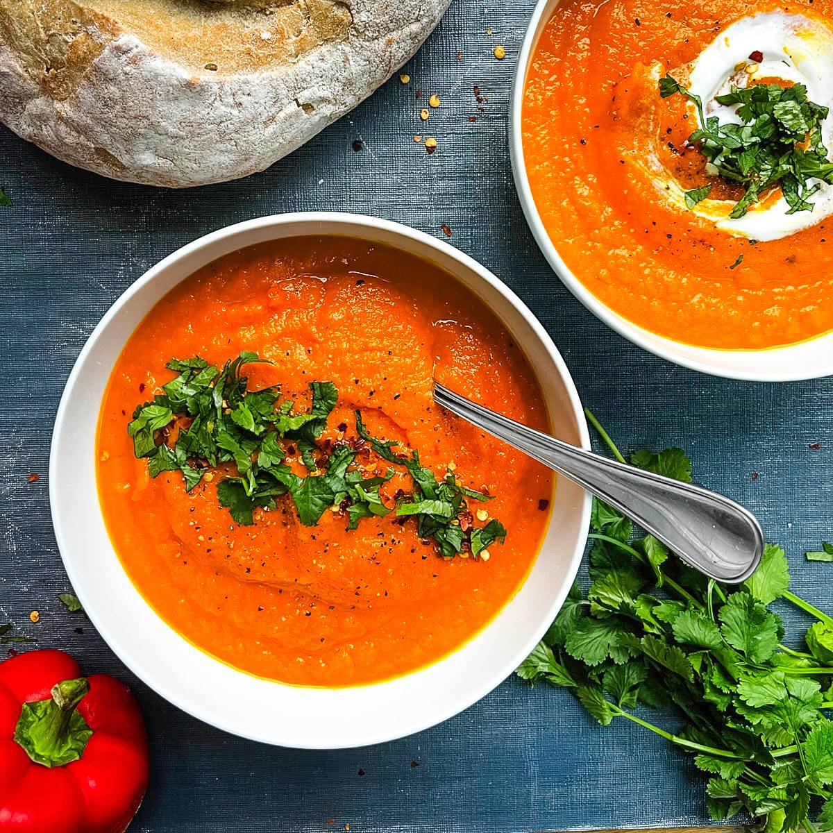 carrot and red pepper soup topped with fresh coriander.