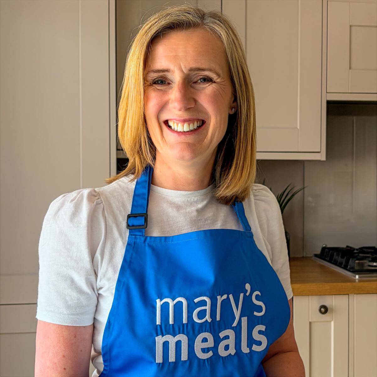 image of claire wearing mary's meals apron