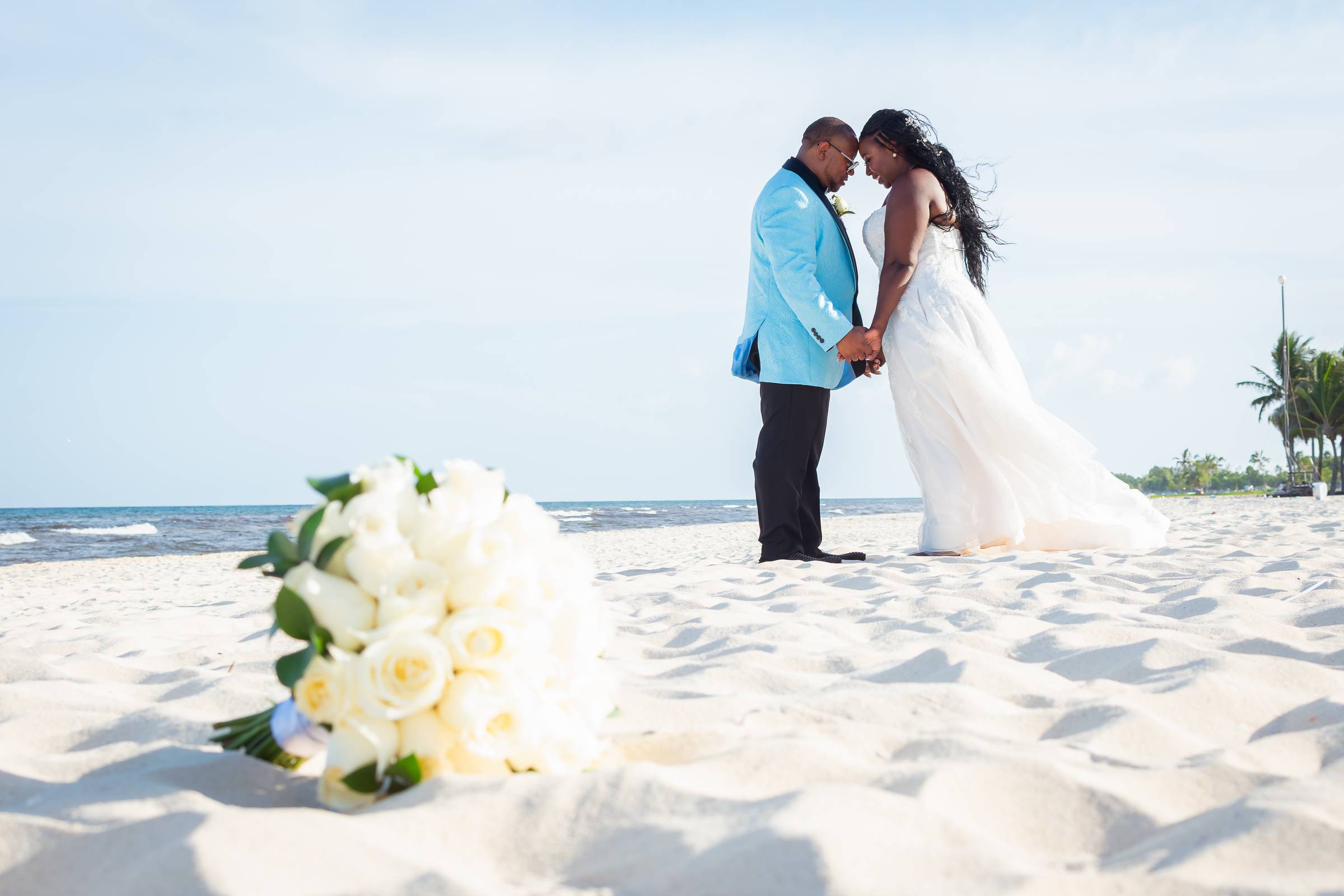 African American bride & Groom on beach following their wedding