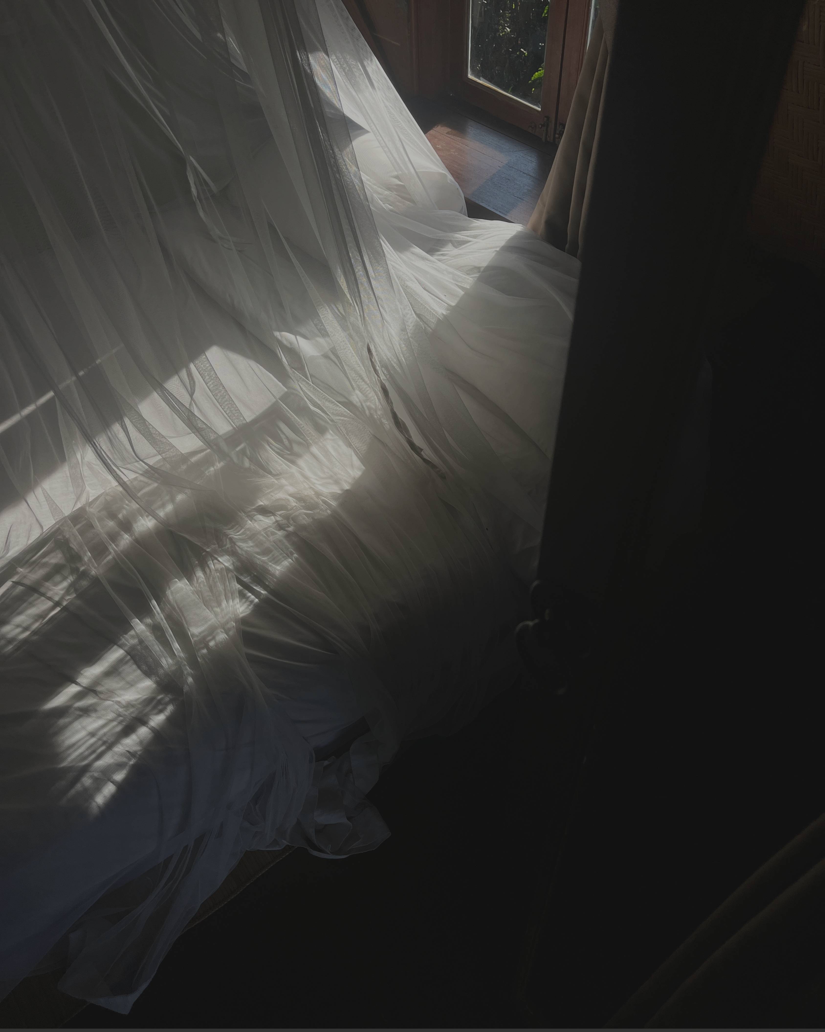 Ethereal Sheer Curtain with Light Streaming Through onto Bed