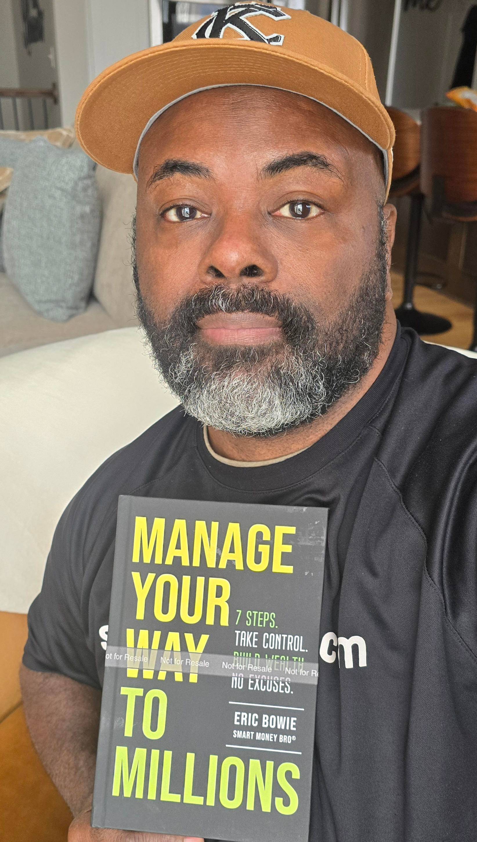 Smart money bro holding book Manage Your Way To Millions