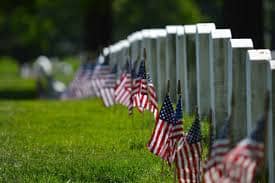 American flags next to graves on Memorial Day holiday