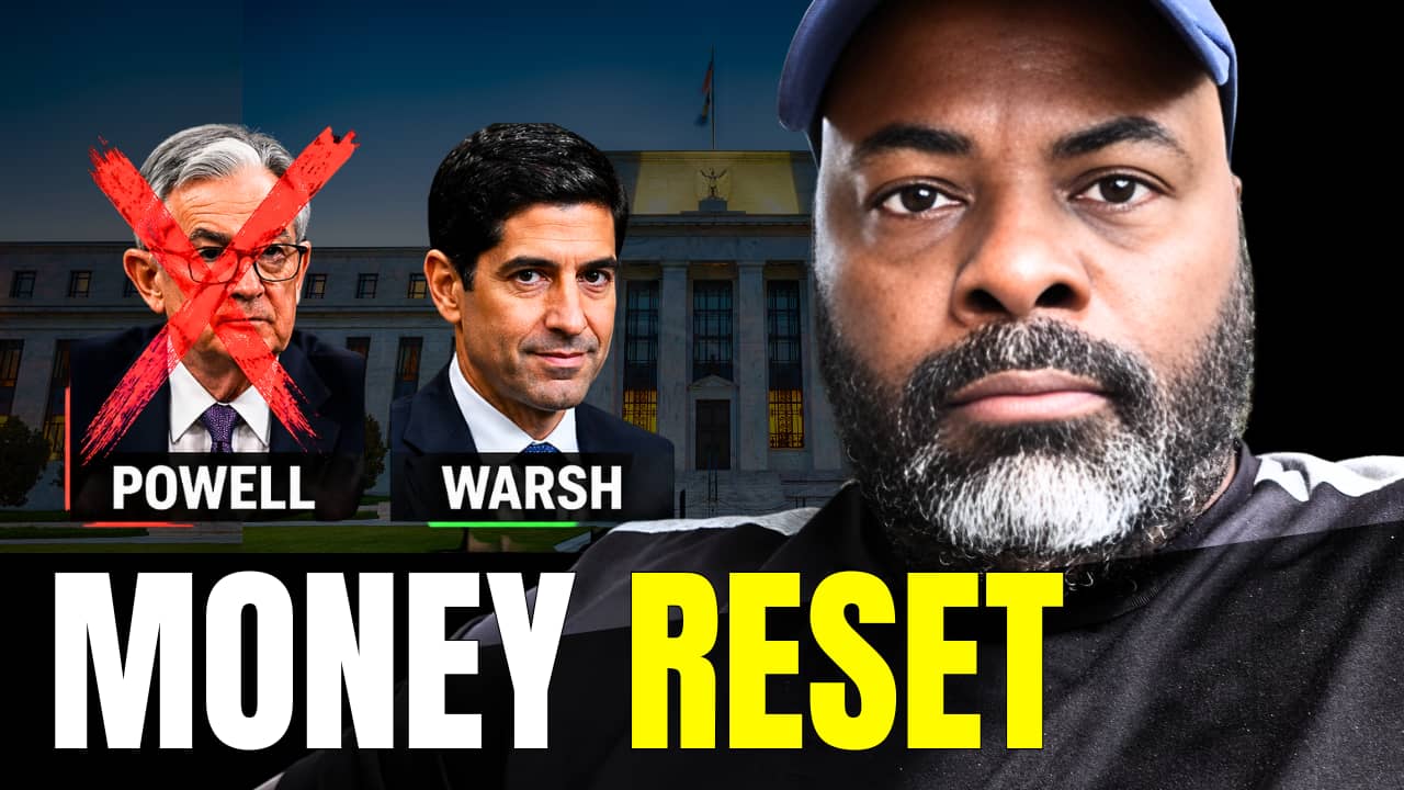 Man with serious expression on right, Jerome Powell on left crossed out with a red X, Kevin Warsh next to him, Federal Reserve building in background, bold text ‘MONEY RESET’ at bottom.