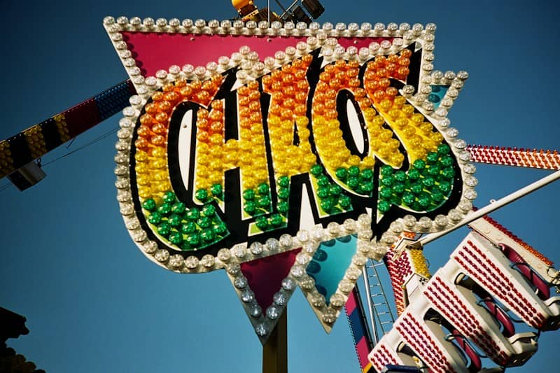 a large lighted sign that says "chaos"