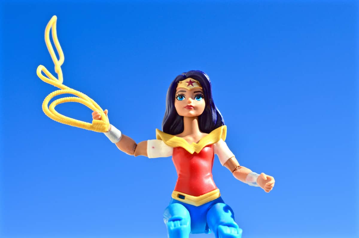 An action figure of superhero Wonder Woman with a yellow lasso.