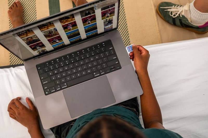 Person inserting sd card into laptop