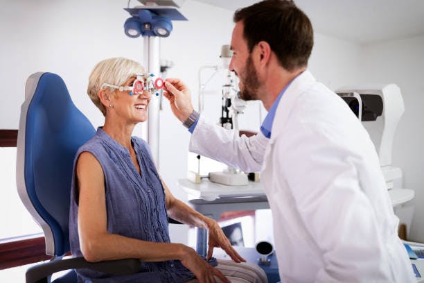 A senior visiting the optometrist getting her eyes examined.. 