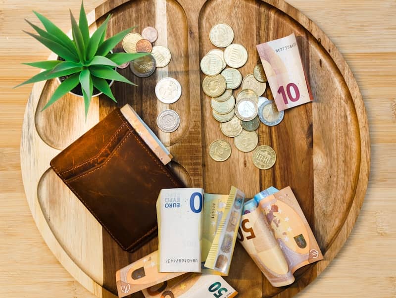 A wooden table topped with lots of money