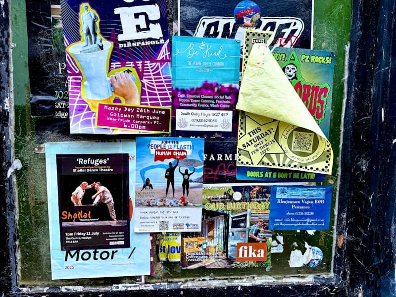 Collage of various flyers and posters on a wall.