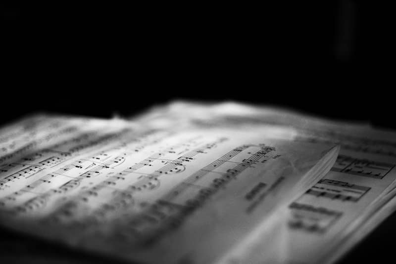 Sheet music on a table with dramatic lighting