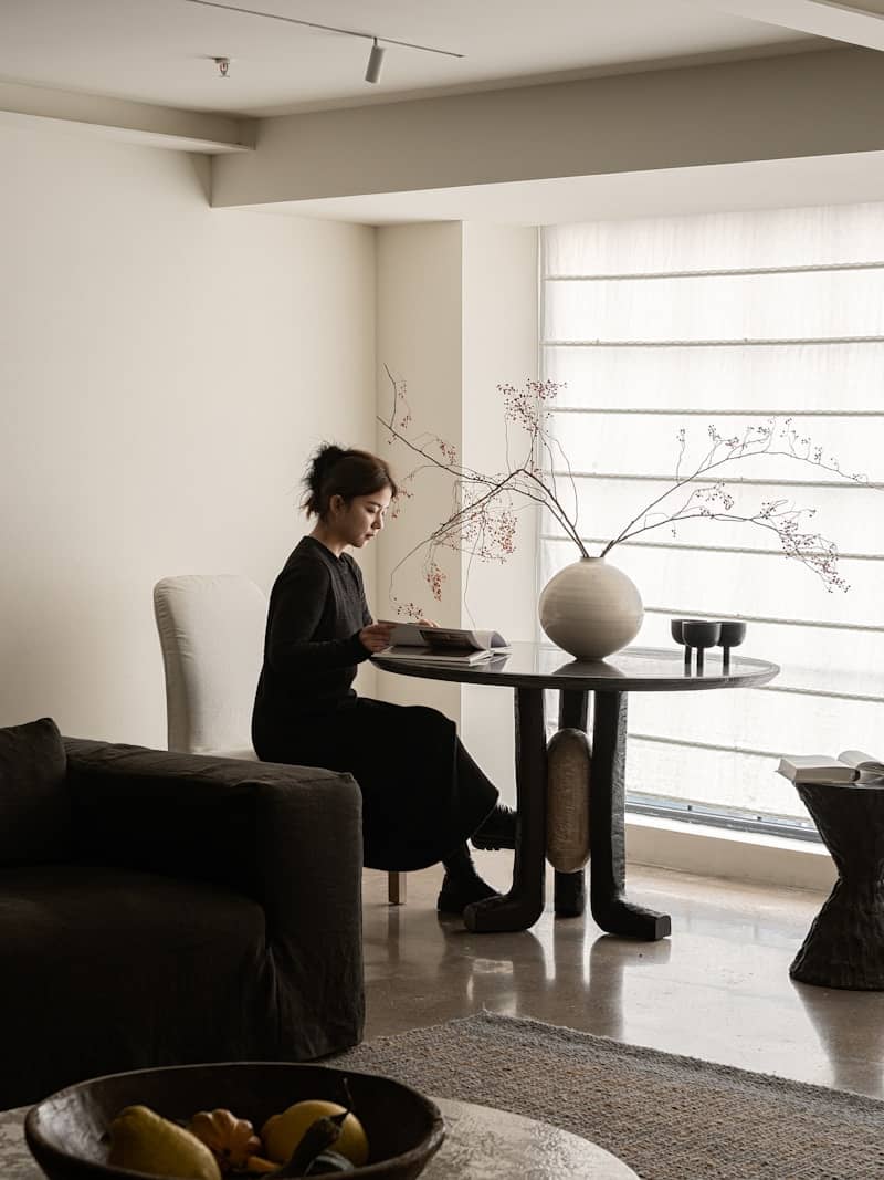 A woman sitting at a table in a living room