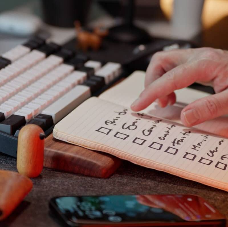 Checking items off a list on a notepad.