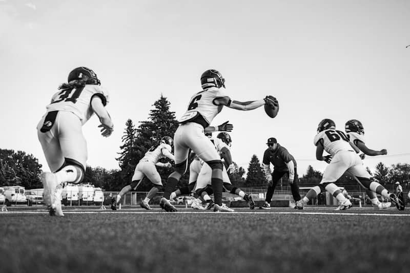 Football players in action on field during game