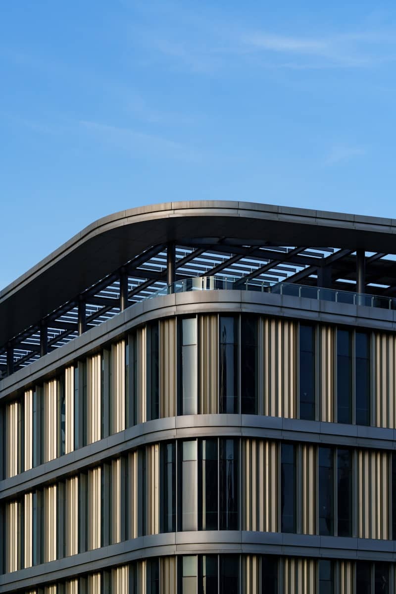 Modern building with curved roof against blue sky