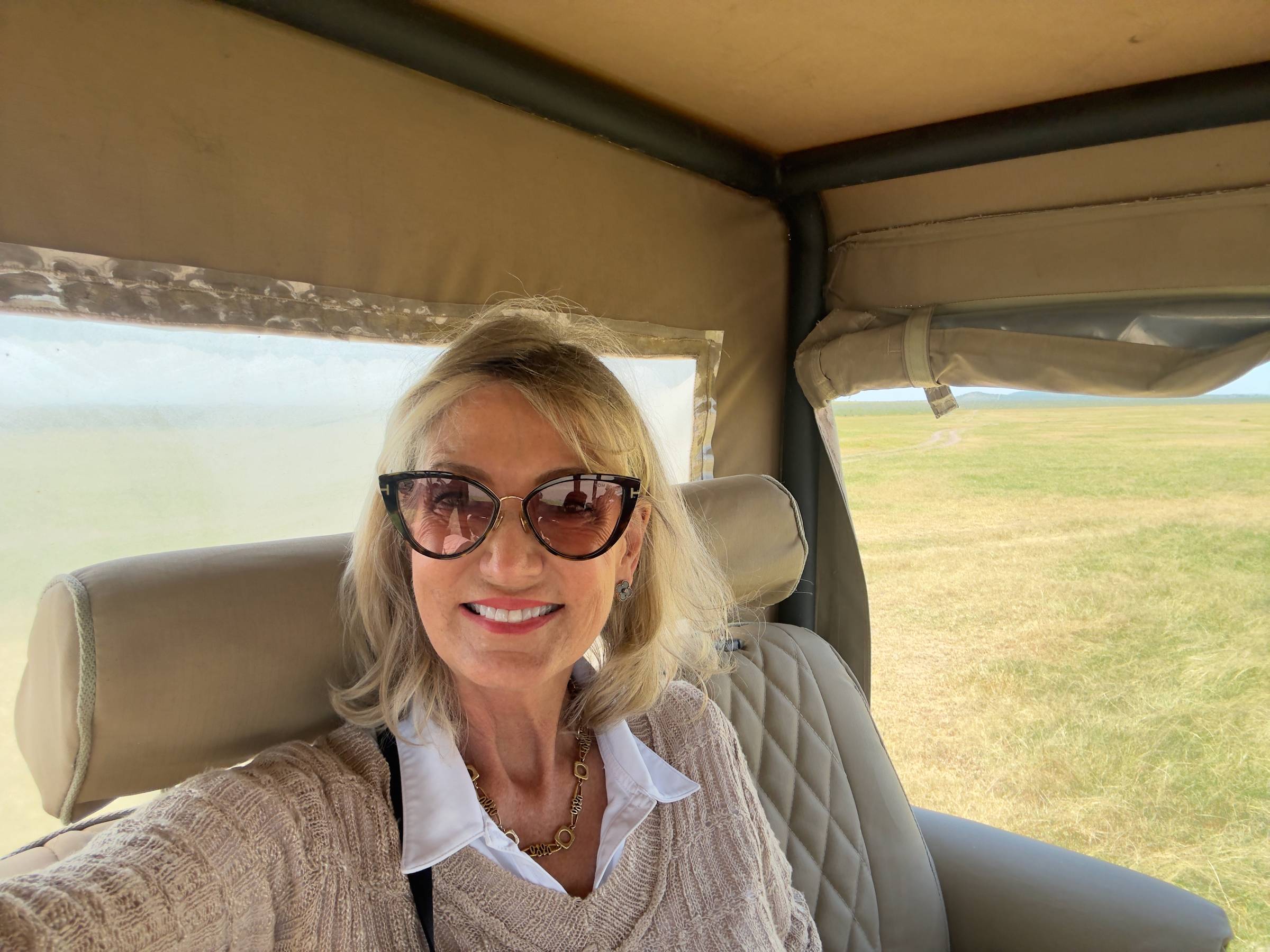Woman in the back of a safari jeep
