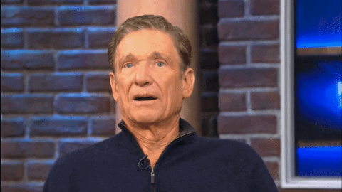 Image is a GIF of Maury Povich with his mouth open putting his hands on his cheeks in an "oh no" gesture..