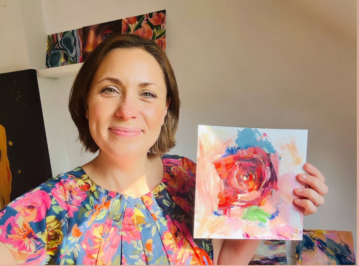 Louise Thompson holding rose painting