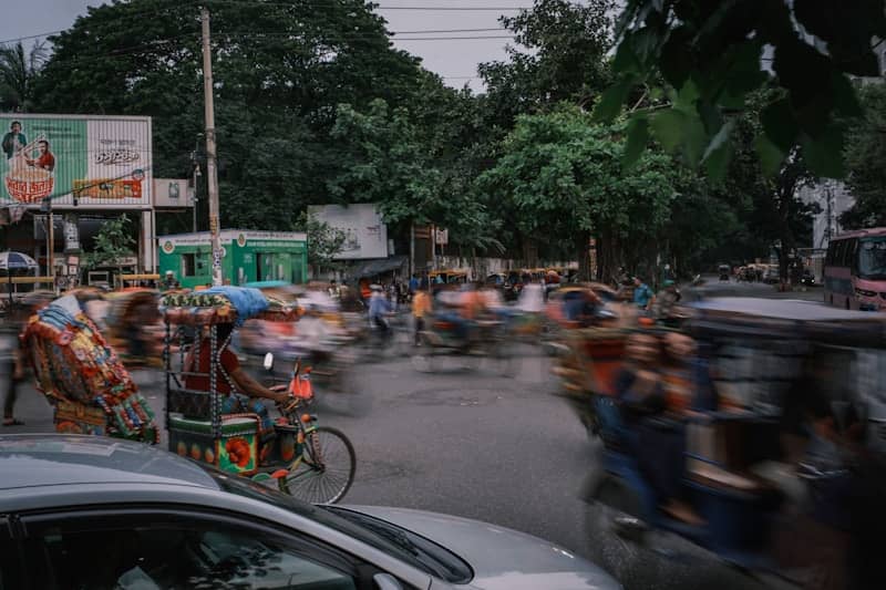 Busy street scene with blurred motion and vehicles.