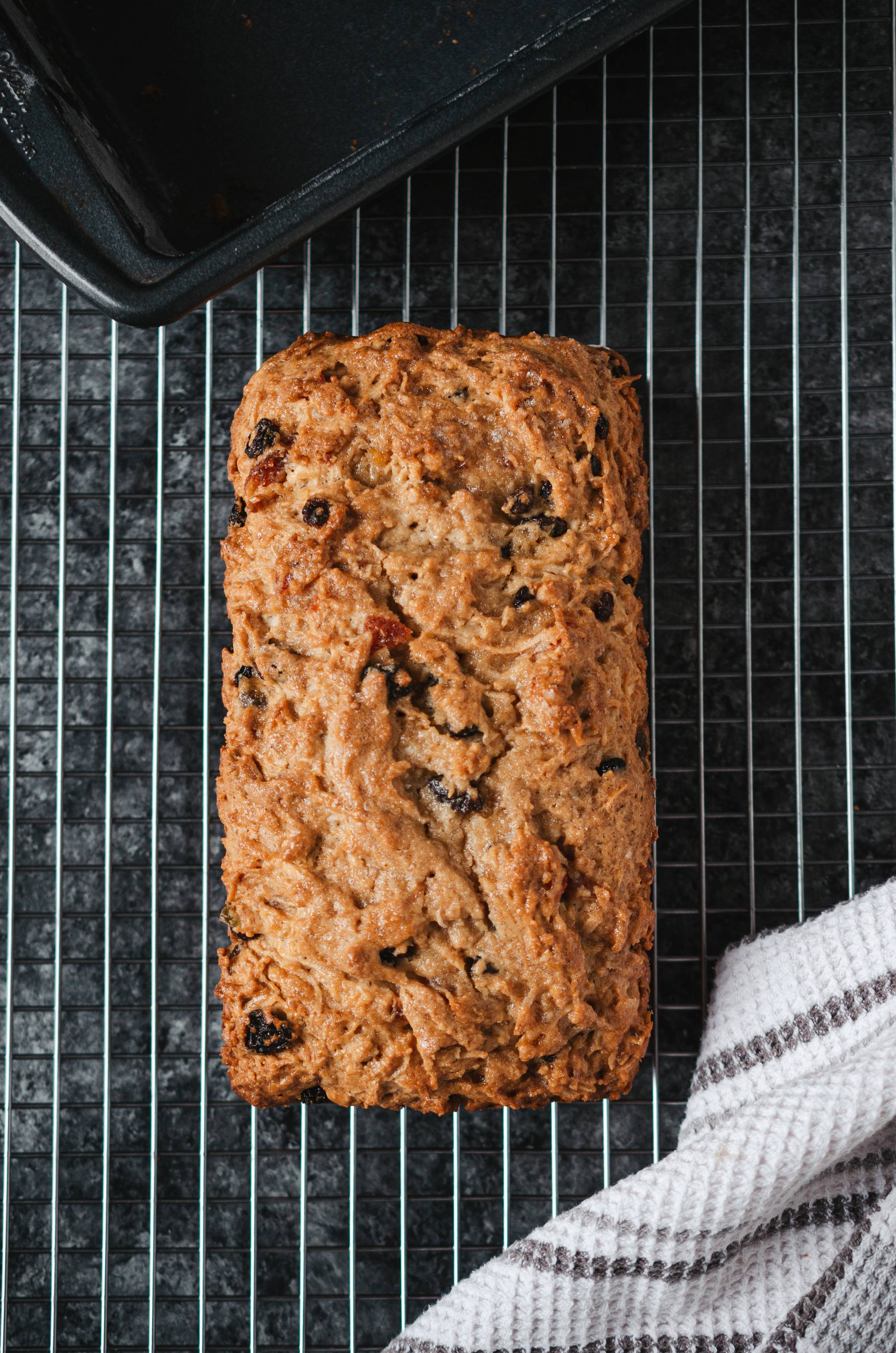 A loaf of Trinidadian sweet bread on a cooling rack.