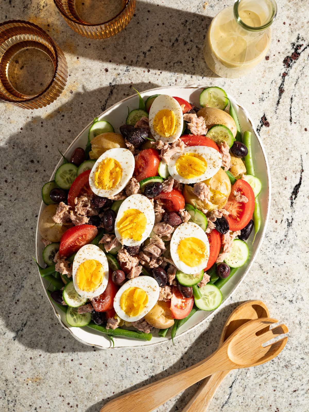 A platter of tuna Nicoise salad topped with jammy eggs.