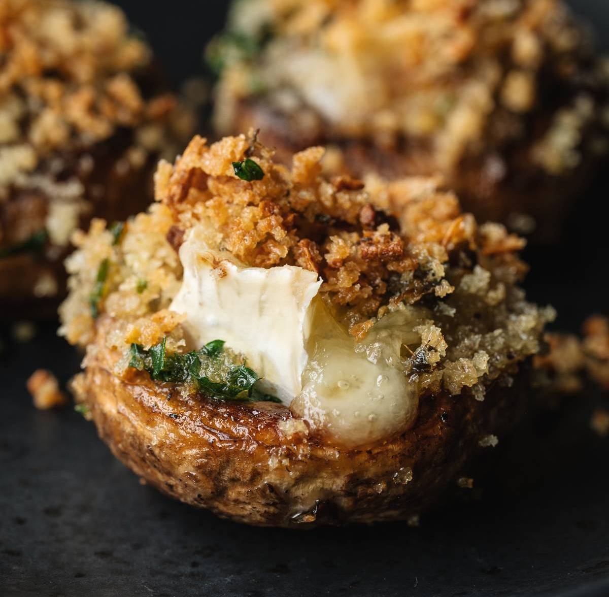 A mushroom stuffed with melting brie cheese.