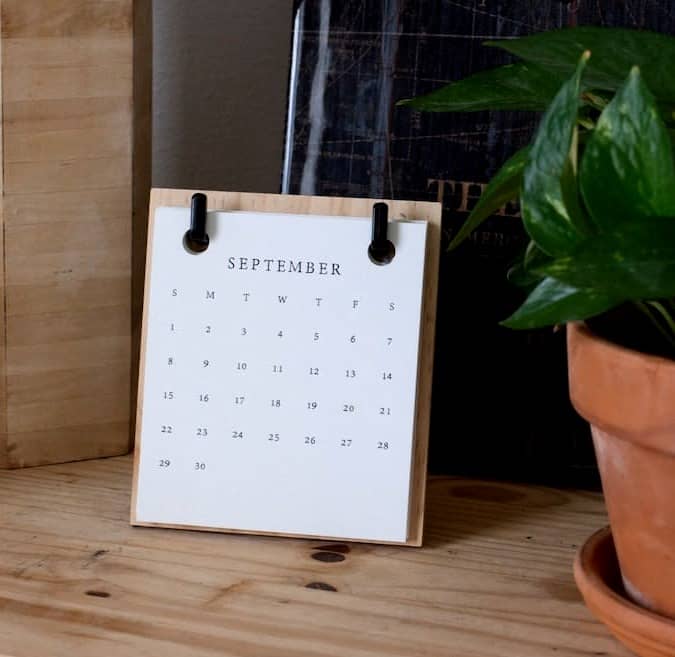 white and black polka dot gift box on white textile