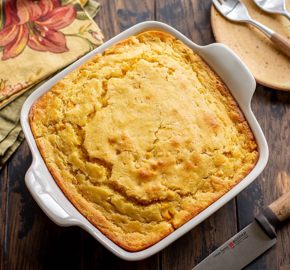 A casserole filled with fresh baked corn pudding