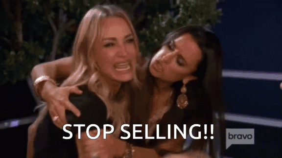  two women are fighting with the words stop selling written in white