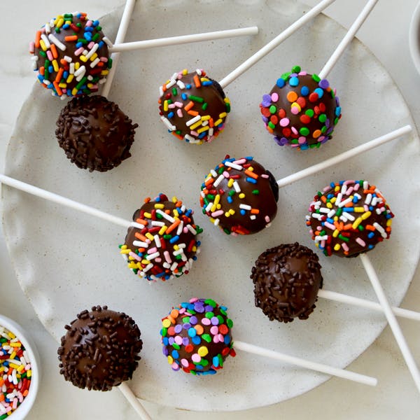 No-bake chocolate cookie pops with rainbow sprinkles.