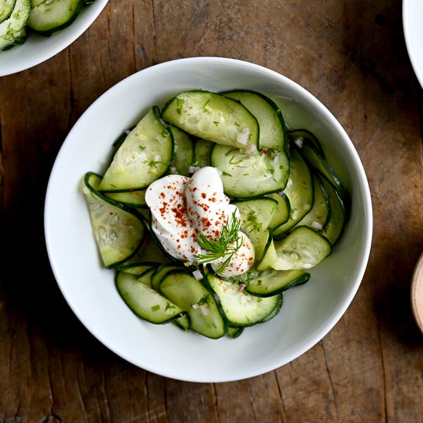 Hungarian Cucumber Salad topped with a dollop of sour cream.