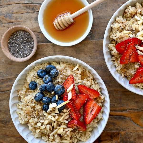 Quinoa breakfast bowls with fruit, chia seeds and honey.