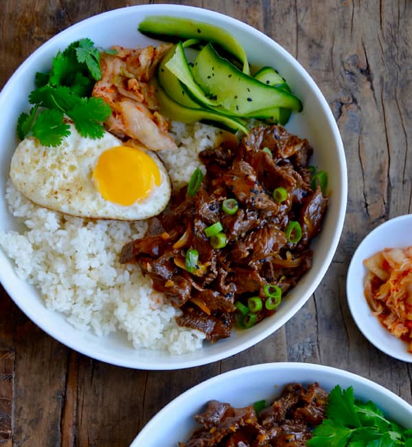Beer-battered onion rings piled high on a plate.